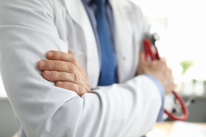 Hands Of Doctor In White Coat Holding Stethoscope